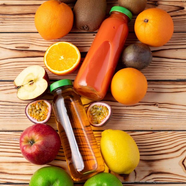 Fruits and freshly squeezed fruits juice on wooden table